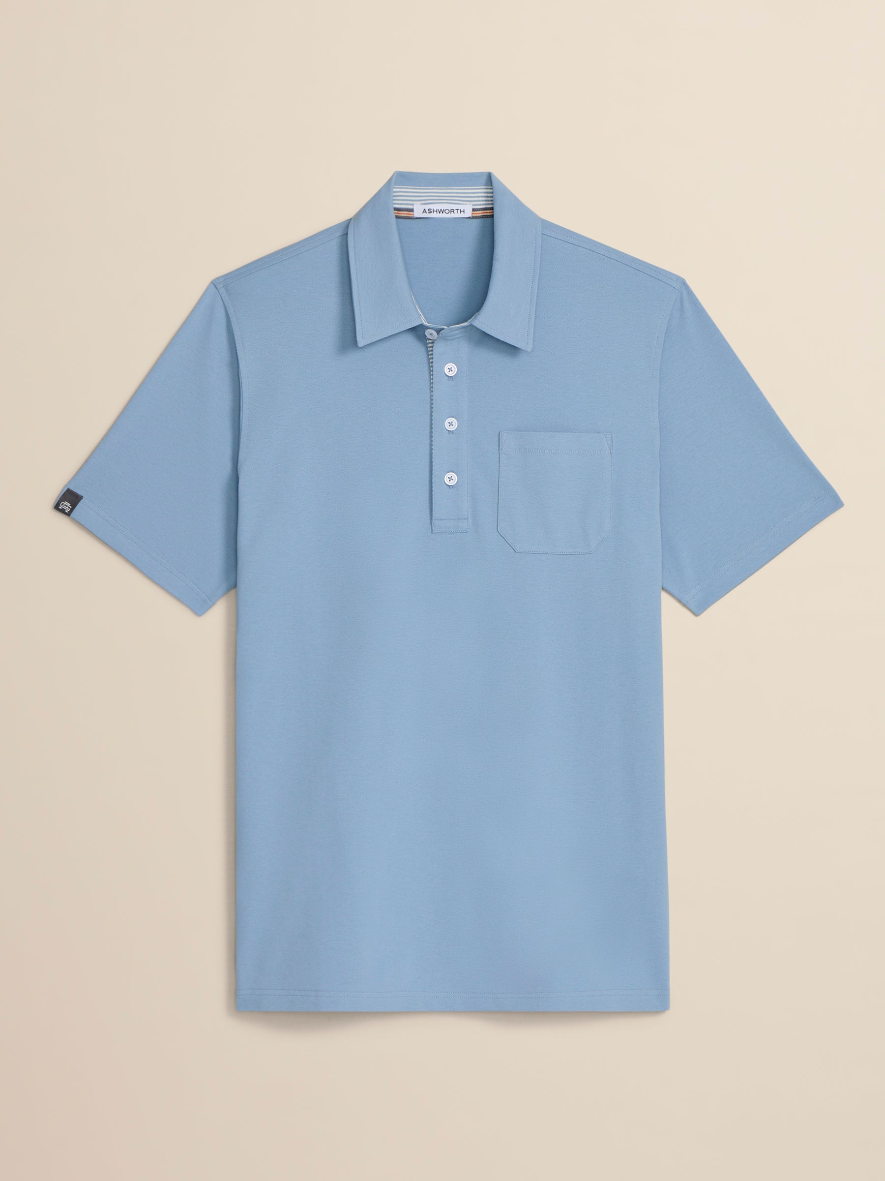 Light blue polo shirt on a beige background